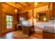 Study with wood paneling, built-in desk, and hardwood floors at 1051 Lake Rutledge Rd, Rutledge, GA 30663