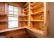 Bright pantry featuring beautiful, wooden shelving beside a window offering plenty of room for storage at 1051 Lake Rutledge Rd, Rutledge, GA 30663
