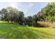 Scenic view of a pond surrounded by lush greenery, mature trees, and a wooden fence at 1051 Lake Rutledge Rd, Rutledge, GA 30663