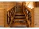 Wooden staircase showcasing detailed wood carvings leading to the upper level at 1051 Lake Rutledge Rd, Rutledge, GA 30663