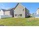 Spacious backyard with lush green grass and a view of the home's rear exterior at 2384 Hastings Manor Ln, Hampton, GA 30228