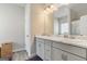 Bathroom with double sink vanity, white countertop, gray cabinets, and wood-look flooring at 2384 Hastings Manor Ln, Hampton, GA 30228