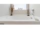 Bright bathroom featuring a white tub with decorative items on its ledge under a window at 2384 Hastings Manor Ln, Hampton, GA 30228