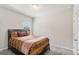 Cozy bedroom features carpet and a dark wood bed frame with a patterned comforter at 2384 Hastings Manor Ln, Hampton, GA 30228