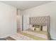 Well-lit bedroom showcasing soft carpet and a doorway leading to an additional room at 2384 Hastings Manor Ln, Hampton, GA 30228