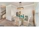 Dining room featuring modern chandelier and decor, a glass table, and seating for six at 2384 Hastings Manor Ln, Hampton, GA 30228