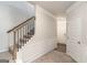 Inviting foyer featuring a staircase with iron railings, carpeted steps, and fresh, neutral paint at 2384 Hastings Manor Ln, Hampton, GA 30228