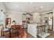 Bright kitchen features stainless appliances, a center island with bar seating, and an adjacent dining area at 2384 Hastings Manor Ln, Hampton, GA 30228