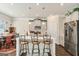 Bright kitchen features stainless appliances, a center island with bar seating, and an adjacent dining area at 2384 Hastings Manor Ln, Hampton, GA 30228