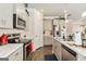 Bright kitchen featuring stainless steel appliances, ample counter space and grey cabinetry at 2384 Hastings Manor Ln, Hampton, GA 30228