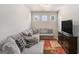 Cozy living room with a large sectional sofa, television, and neutral decor at 2384 Hastings Manor Ln, Hampton, GA 30228
