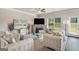 Bright living room offering large sofas, a ceiling fan, and a large window at 2384 Hastings Manor Ln, Hampton, GA 30228