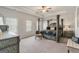 Bedroom with trey ceilings and a four post bed and sitting area at 2384 Hastings Manor Ln, Hampton, GA 30228