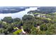 Stunning aerial shot showcasing the property's proximity to a serene lake and surrounding lush greenery at 285 Acton Dr, Fayetteville, GA 30215