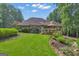 Lush green backyard with manicured lawn and elegant landscaping, creating a serene outdoor oasis at 285 Acton Dr, Fayetteville, GA 30215