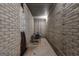 Narrow unfinished basement space with painted brick walls and overhead fluorescent lighting at 285 Acton Dr, Fayetteville, GA 30215
