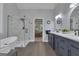 Bright bathroom with a soaking tub, frameless glass shower, and double sink vanity with stylish countertops at 285 Acton Dr, Fayetteville, GA 30215