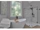Bright bathroom featuring a modern soaking tub, frameless glass shower, and large windows at 285 Acton Dr, Fayetteville, GA 30215