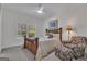 Cozy bedroom featuring a wood-frame bed, ceiling fan, window and a chair with footstool at 285 Acton Dr, Fayetteville, GA 30215