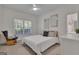 Comfortable bedroom featuring a window, ceiling fan, a soft-colored bed, and rocking chair at 285 Acton Dr, Fayetteville, GA 30215