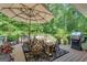Inviting deck area with ample seating, a grill, and beautiful views of the surrounding greenery at 285 Acton Dr, Fayetteville, GA 30215