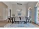 Elegant dining room with modern lighting and arched windows creating a bright and inviting space at 285 Acton Dr, Fayetteville, GA 30215