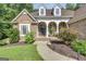 Stunning brick home with dormer windows, beautiful landscaping, and a walkway leading to the front porch at 285 Acton Dr, Fayetteville, GA 30215