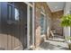 Inviting covered porch with outdoor seating, brick accents, and a view of the landscaped front yard at 285 Acton Dr, Fayetteville, GA 30215