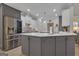 Kitchen with an island, stainless steel appliances, modern lighting, and light countertops at 285 Acton Dr, Fayetteville, GA 30215