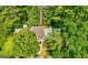 Aerial view of the property showcasing the roof, landscaping, and surrounding trees at 398 Patrick Henry Ct, Riverdale, GA 30274