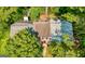 Overhead view of home with brick facade, walkway, roof and mature trees at 398 Patrick Henry Ct, Riverdale, GA 30274