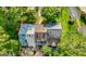 The property is an aerial view that features multiple roof styles and mature trees at 398 Patrick Henry Ct, Riverdale, GA 30274