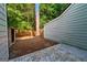 The backyard features a concrete patio, privacy fence, and mature trees at 398 Patrick Henry Ct, Riverdale, GA 30274