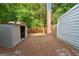 Fenced backyard with storage shed and mature trees, offering a private outdoor space at 398 Patrick Henry Ct, Riverdale, GA 30274