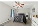 Cozy bedroom with a ceiling fan, plush carpet, and plenty of natural light from the window at 398 Patrick Henry Ct, Riverdale, GA 30274