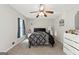 Comfortable bedroom with ceiling fan, carpeted floors, and natural light through the window at 398 Patrick Henry Ct, Riverdale, GA 30274