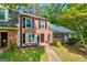 Beautiful brick townhome with lush front lawn and mature trees at 398 Patrick Henry Ct, Riverdale, GA 30274