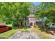 Charming two-story home with a brick facade, lush lawn, and mature trees at 398 Patrick Henry Ct, Riverdale, GA 30274