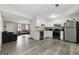 Modern kitchen with stainless appliances, white cabinets, and open access to living room at 398 Patrick Henry Ct, Riverdale, GA 30274