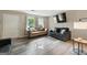 Open-concept living room with natural light, wood-look floors, and modern decor at 398 Patrick Henry Ct, Riverdale, GA 30274