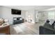 Comfortable living room featuring neutral paint, wood-look floors, and modern furnishings at 398 Patrick Henry Ct, Riverdale, GA 30274