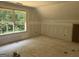 Bedroom features a large window with natural light and unfinished flooring at 5555 Hwy 155 N, Stockbridge, GA 30281