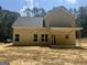 Two-story home with bright yellow siding, featuring a covered back porch perfect for relaxation and enjoyment at 5555 Hwy 155 N, Stockbridge, GA 30281