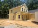 Charming two-story home featuring bright yellow siding, covered porch perfect for relaxation and outdoor enjoyment at 5555 Hwy 155 N, Stockbridge, GA 30281