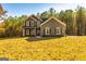 Charming two-story home with gray siding, black shutters, and a beautifully landscaped front yard at 5555 Hwy 155 N, Stockbridge, GA 30281