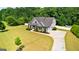 Aerial view of a beautifully landscaped home with a large yard and a winding driveway surrounded by trees at 195 Berry Hill Ln, Tyrone, GA 30290