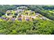 Aerial view of a quiet neighborhood featuring lush landscaping, mature trees and a pond at 195 Berry Hill Ln, Tyrone, GA 30290