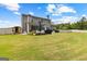Expansive backyard featuring a patio, grill, wooden sauna and lush green lawn at 195 Berry Hill Ln, Tyrone, GA 30290