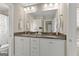 Bright bathroom featuring double sinks, granite countertops, white cabinetry, and modern fixtures at 195 Berry Hill Ln, Tyrone, GA 30290