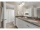 Bright bathroom featuring double sink vanity with granite countertop and white cabinets at 195 Berry Hill Ln, Tyrone, GA 30290